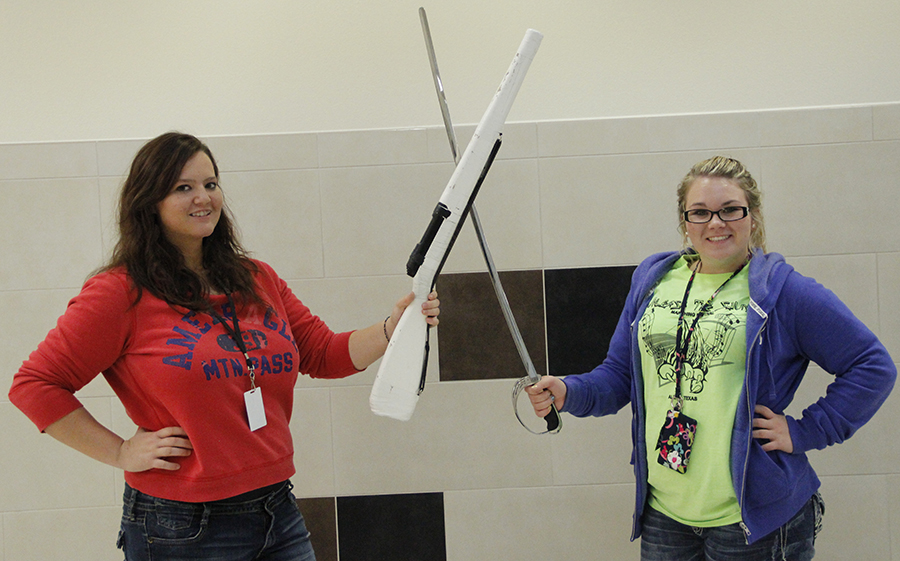 Kelsi Adams and Mayci Drake pose with their rifle and saber. Photo by Lasha Kelley.