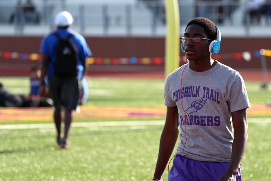 Hasan Mustapha walks to the track to prepare for his 4x400 at the district meet on April 10. Photo by Jezza Bull-Briones