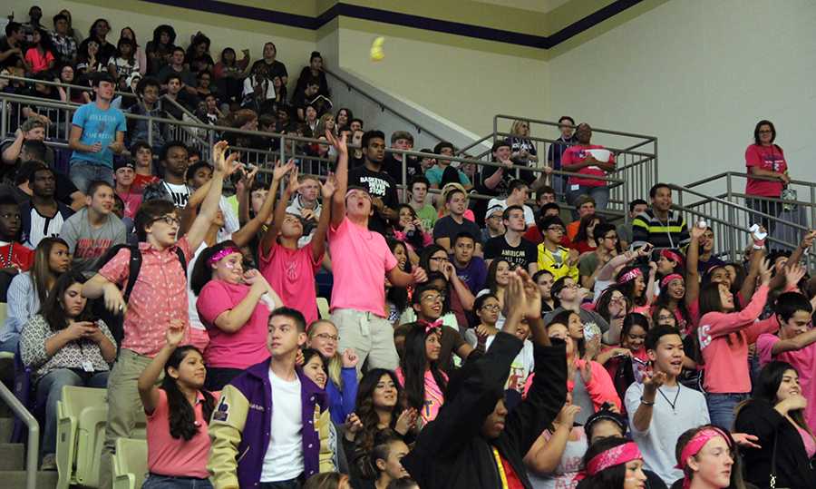 Dressed in pink, several students reach for the candy from the cheerleaders at the unofficial Pink Out pep rally Oct. 10. The "official" Pink Out pep rally took place Oct.24. Photo by Nicholas Alvarez.