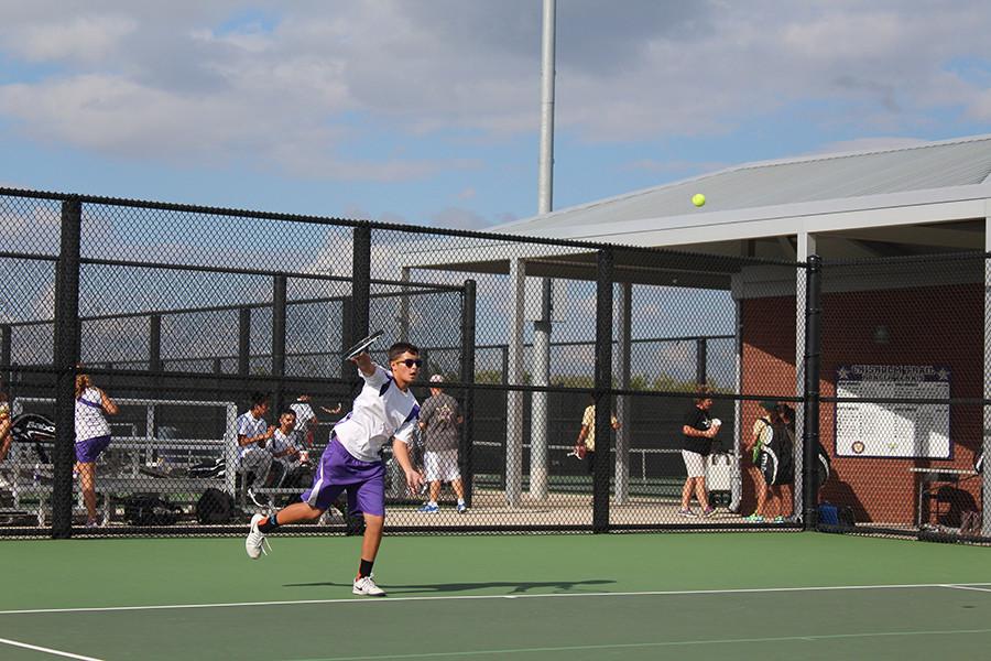 Freshman Jake McGuire serves in a doubles match against Birdville. McGuire made the varsity team as a freshman. Photo by Fatima Nova