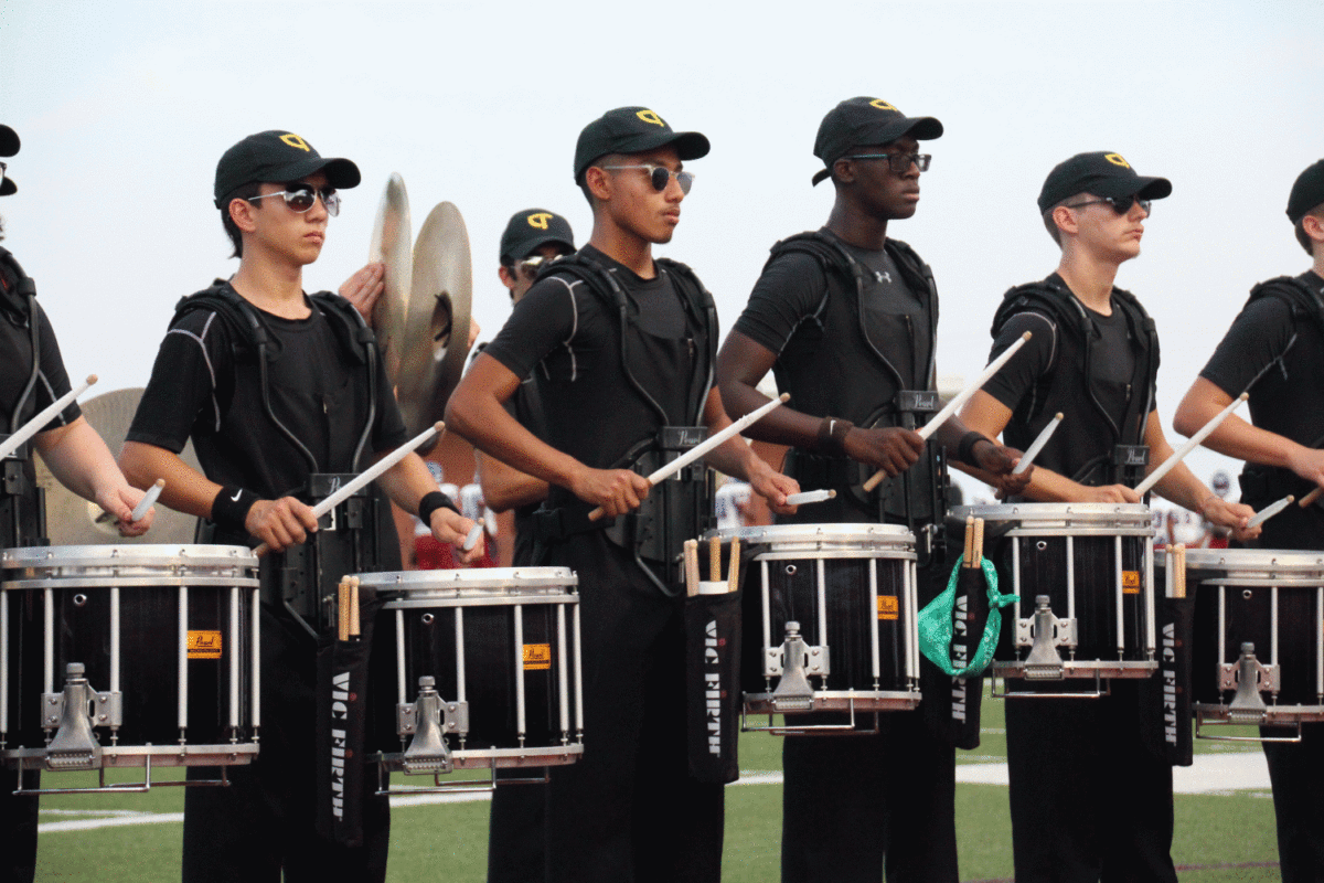 Snare drums play for the band as they march into the stands.