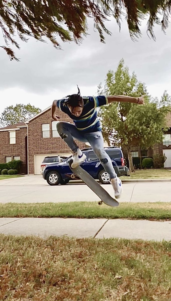 Sophomore+Paul+Herrera+on+his+skateboard.