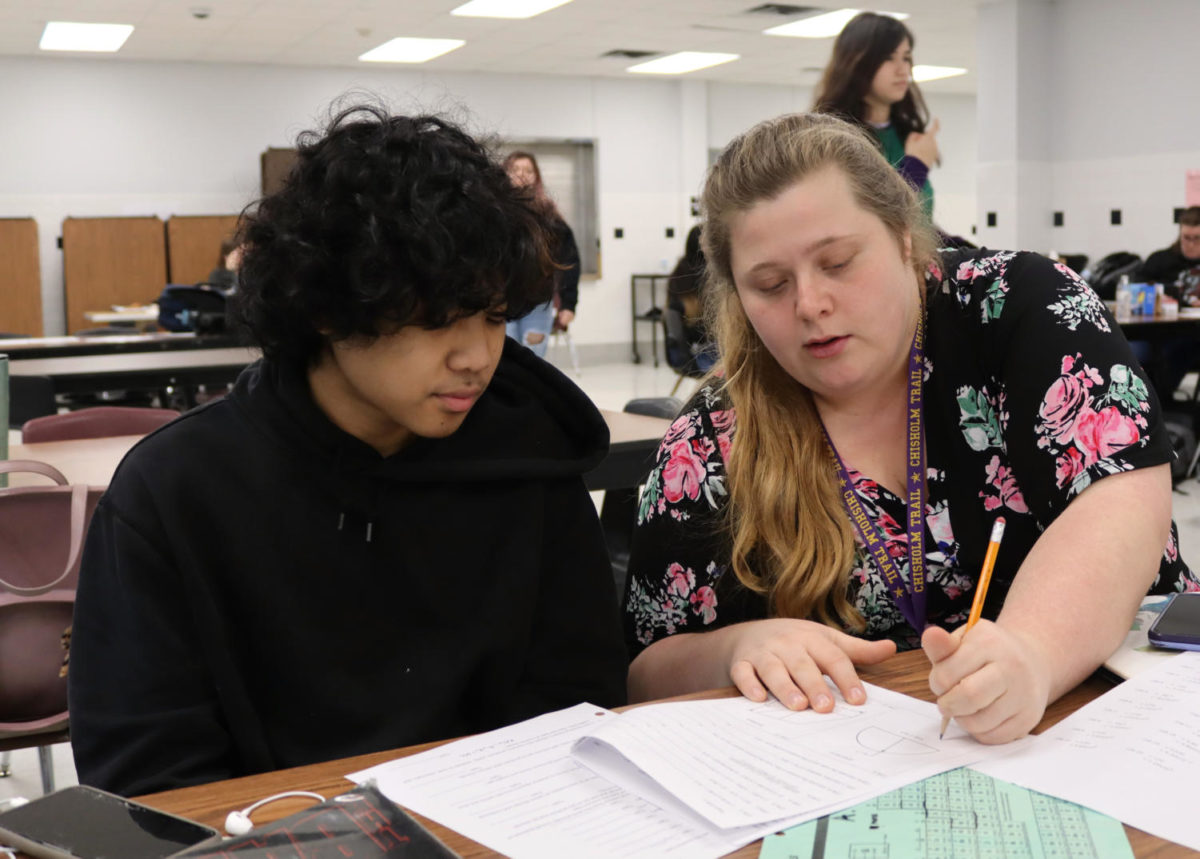 Wokring their way through a practice math test, yearbook advisor Cortney Wood and Peter Anongdeth, 10, prepare for Peter’s contest on Saturday, Feb. 11, 2023. Photo by Sydney Hawkins, 11