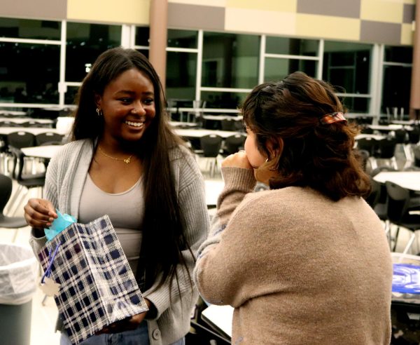 Senior Kaleena Harrison receives a prize from a lottery raffle hosted by senior Citlali Lara. The prize was a $15 Sonic gift card. "I thought it was something sweet," Lara said. "Every memory that I’ve had at Sonic was pretty great, so that’s why I was like ‘Why not Sonic?’ It’s something that I feel like everyone could enjoy, regardless of who it is.” 